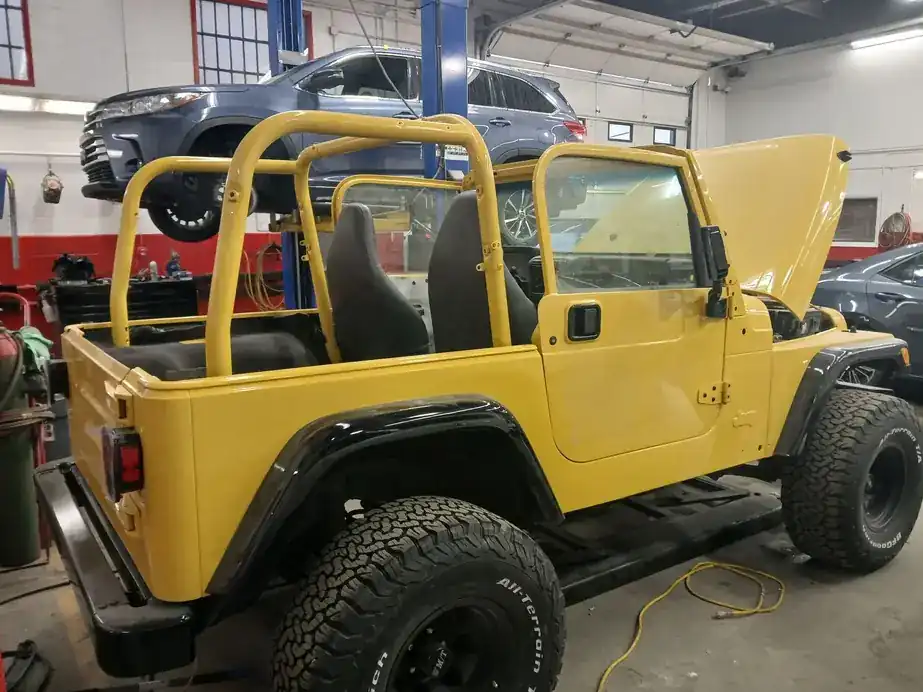 The yellow Jeep parked in the bay