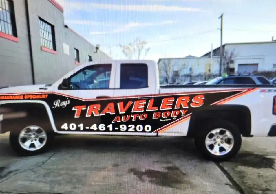 The Ray's Travelers branded truck lettered Insurance Specialist with the shop phone number